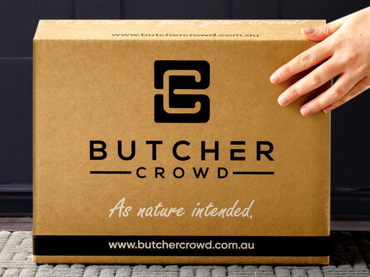A ButcherCrowd delivery box handed over at a front door