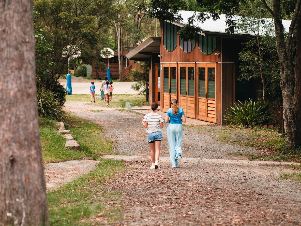 Families walking the bush path into Samford Steiner school
